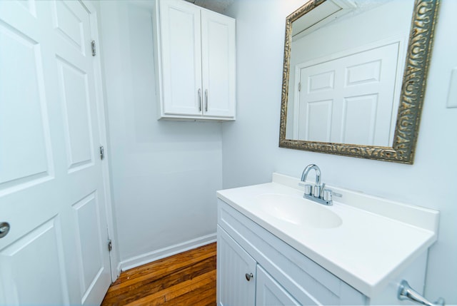 bathroom featuring vanity and hardwood / wood-style flooring