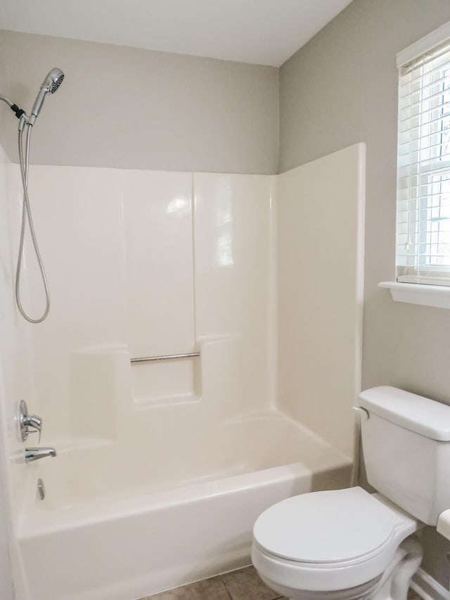 bathroom featuring tile patterned floors, shower / bathtub combination, and toilet