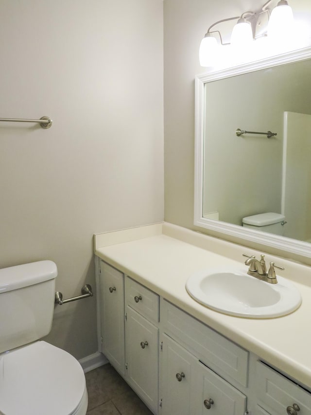 bathroom with vanity, toilet, and tile patterned flooring