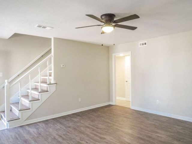 empty room with hardwood / wood-style flooring and ceiling fan