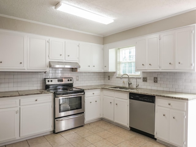 kitchen featuring sink, stainless steel appliances, white cabinets, and light stone countertops