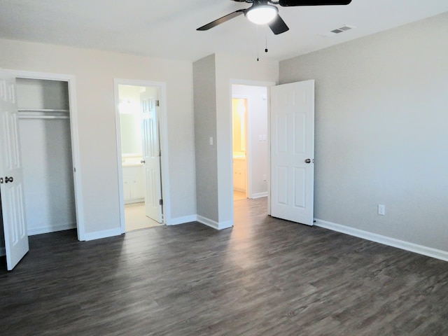 unfurnished bedroom with ceiling fan, connected bathroom, dark hardwood / wood-style flooring, and a closet