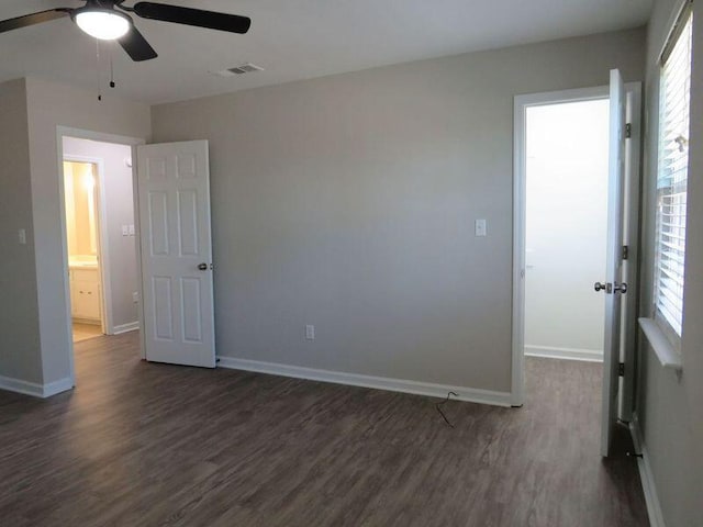 spare room featuring ceiling fan and dark hardwood / wood-style flooring