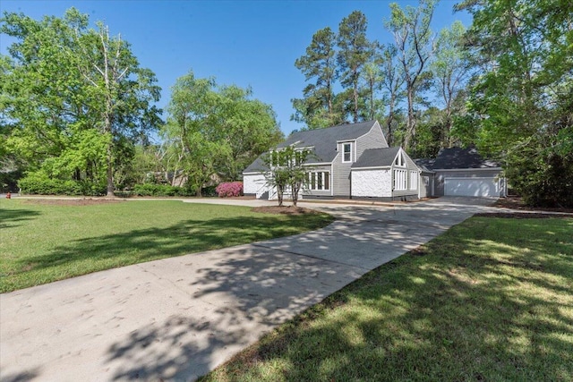 view of front of home featuring driveway, a front yard, and a garage