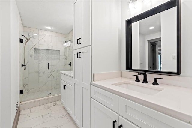 bathroom featuring marble finish flooring, a marble finish shower, vanity, and recessed lighting