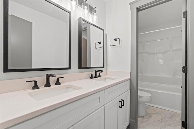 full bath with marble finish floors, toilet, and double vanity