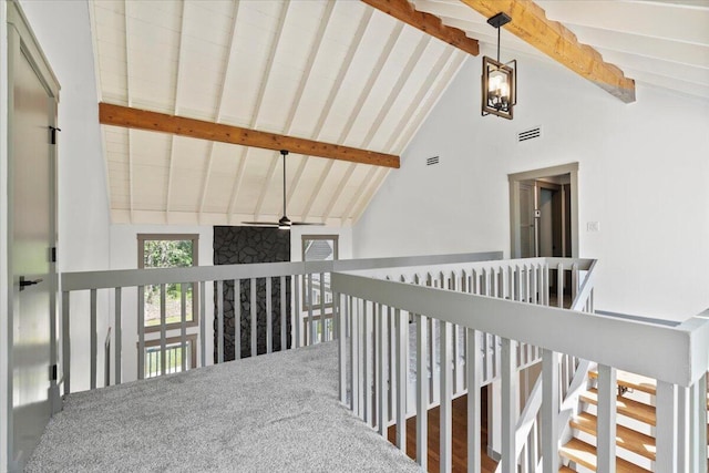corridor with high vaulted ceiling and beam ceiling