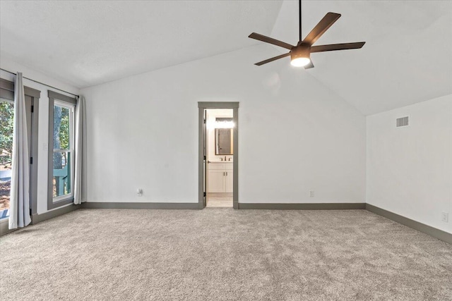 unfurnished room with carpet floors, lofted ceiling, a ceiling fan, and baseboards