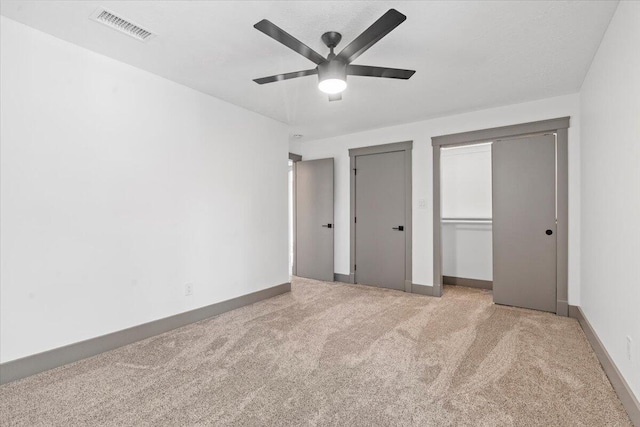unfurnished bedroom with carpet flooring, baseboards, and a ceiling fan