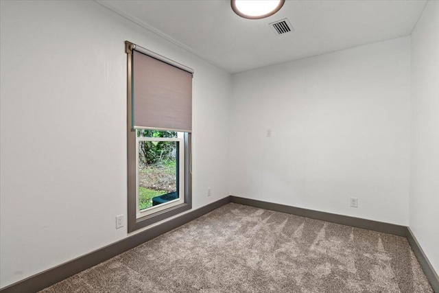 spare room with carpet and baseboards