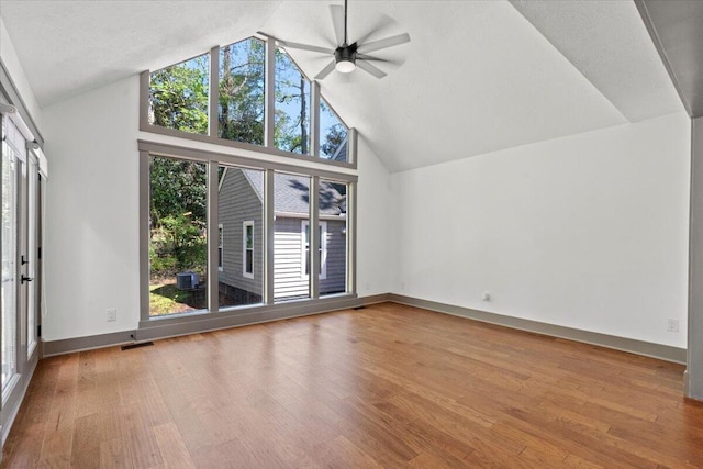additional living space featuring plenty of natural light, ceiling fan, high vaulted ceiling, and wood finished floors