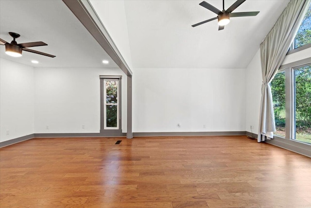 additional living space with a ceiling fan, wood finished floors, recessed lighting, baseboards, and vaulted ceiling