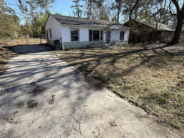 single story home with aphalt driveway