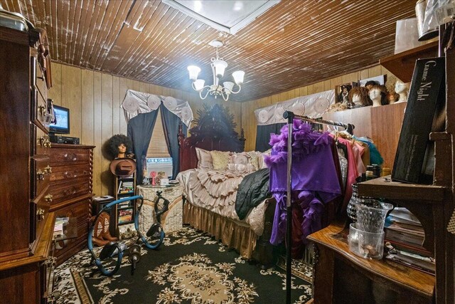 bedroom with a chandelier, wooden walls, and wood ceiling