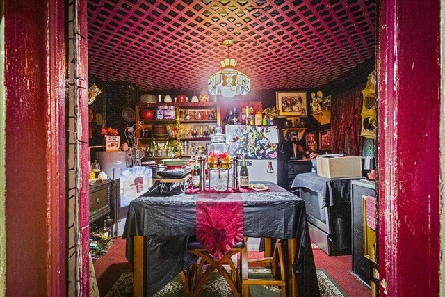 dining space featuring bar area and carpet floors