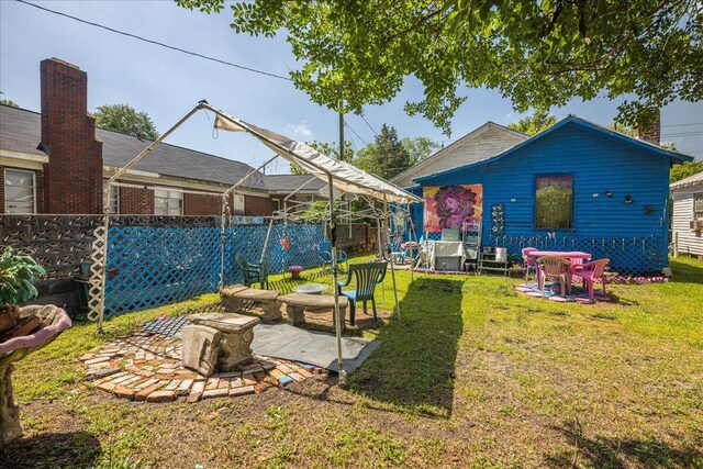 rear view of property featuring a patio area and a yard