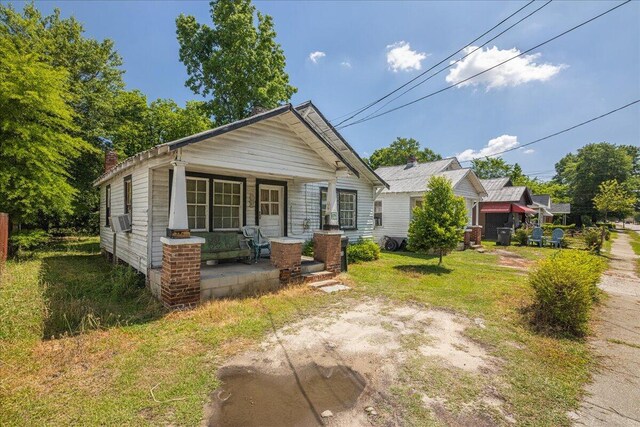 bungalow featuring a porch and cooling unit