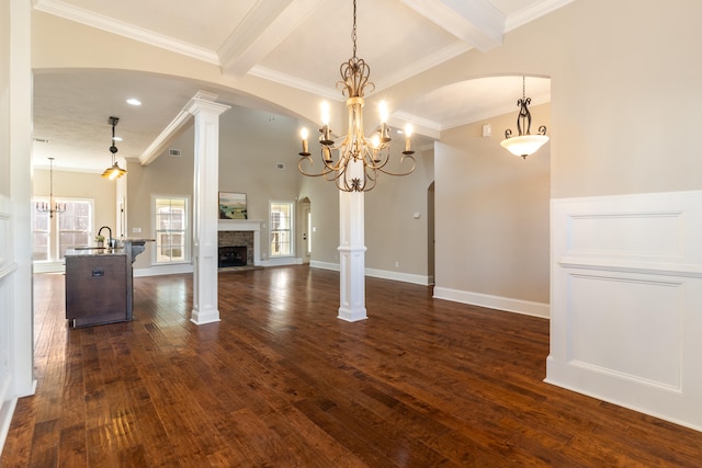 unfurnished living room with beamed ceiling, dark hardwood / wood-style floors, and ornamental molding