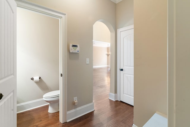 bathroom with hardwood / wood-style floors and toilet