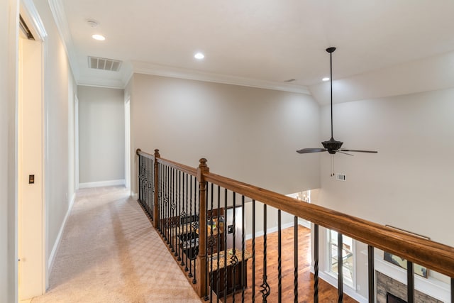 hallway featuring light carpet, vaulted ceiling, and crown molding