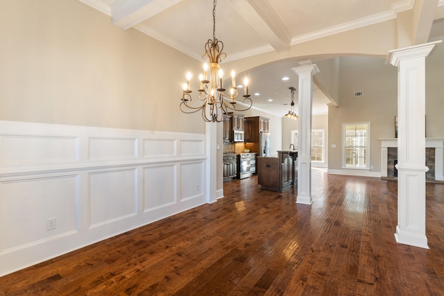 unfurnished dining area featuring dark wood-type flooring, an inviting chandelier, crown molding, ornate columns, and beam ceiling