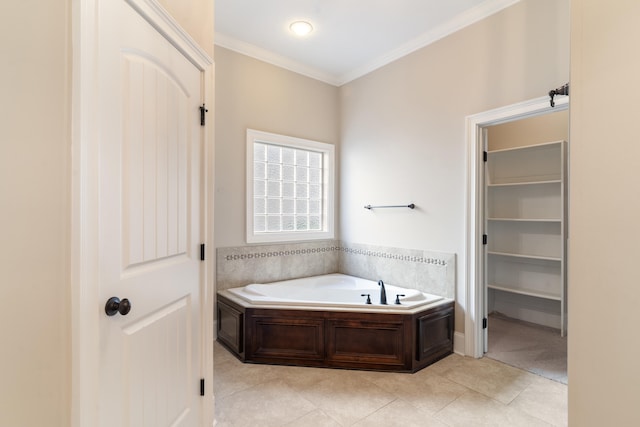 bathroom with tile patterned floors, a tub, and crown molding