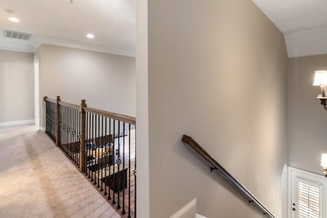 stairs with carpet floors and crown molding