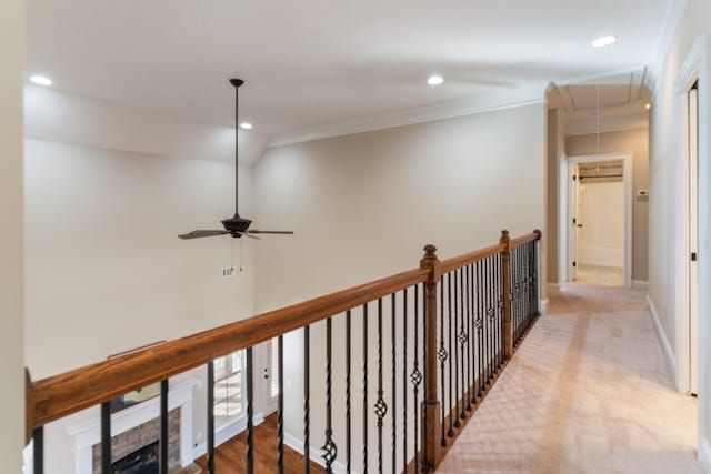 hallway featuring lofted ceiling and crown molding