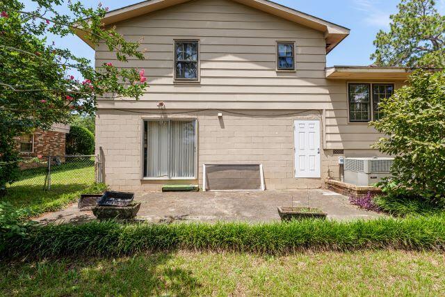 rear view of house featuring a patio and central AC