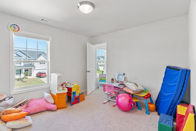 game room with visible vents, a healthy amount of sunlight, and carpet