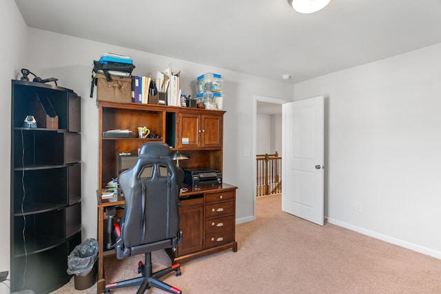 office area with baseboards and light carpet
