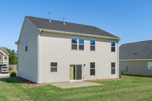 rear view of house with a patio and a yard