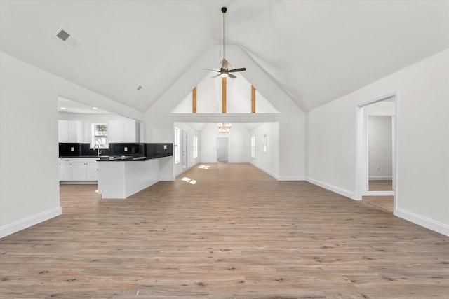 321 Padrick St, Martinez, GA 30907 - unfurnished living room with light wood-style flooring, ceiling fan, baseboards, and high vaulted ceiling