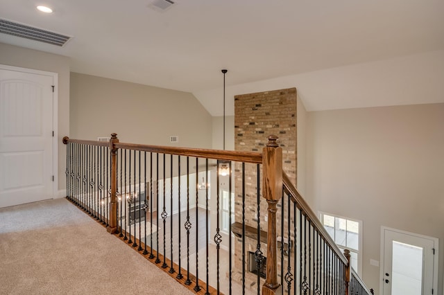 corridor with carpet flooring and lofted ceiling