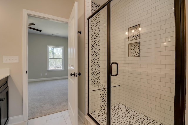 bathroom with tile patterned flooring, vanity, and a shower with door