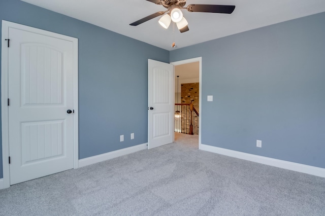 unfurnished bedroom featuring ceiling fan and light colored carpet