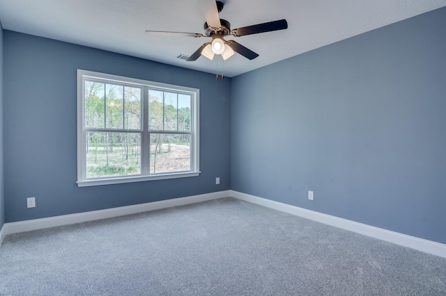 empty room with carpet flooring and ceiling fan