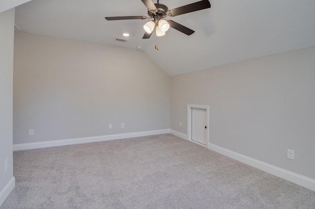 spare room with light carpet, ceiling fan, and lofted ceiling