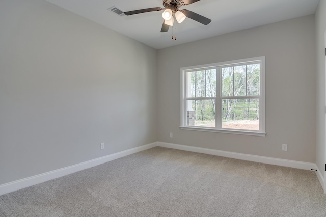 carpeted empty room featuring ceiling fan