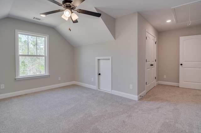 additional living space featuring light colored carpet, ceiling fan, and lofted ceiling