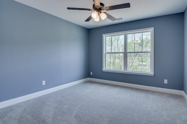 carpeted spare room featuring ceiling fan