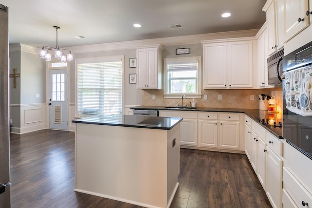 kitchen featuring visible vents, crown molding, dark countertops, dark wood finished floors, and black appliances