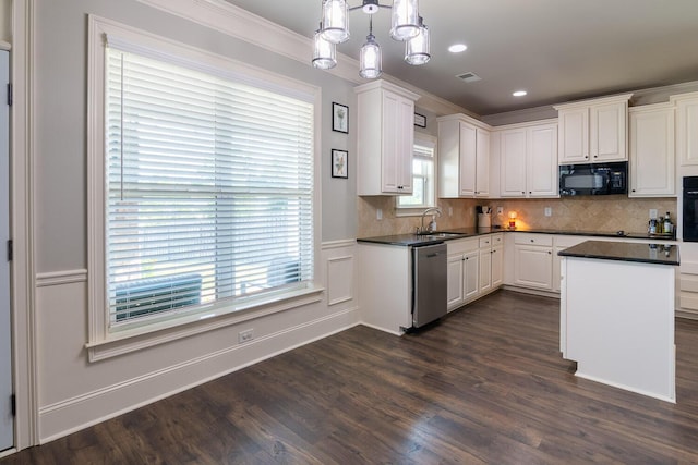 kitchen featuring white cabinets, dark countertops, and black appliances
