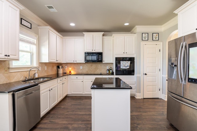 kitchen featuring visible vents, ornamental molding, white cabinetry, a sink, and black appliances