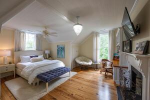 1792 Appleton Rd, Allendale, SC 29810 - bedroom with hardwood / wood-style floors, ceiling fan, lofted ceiling, and a fireplace