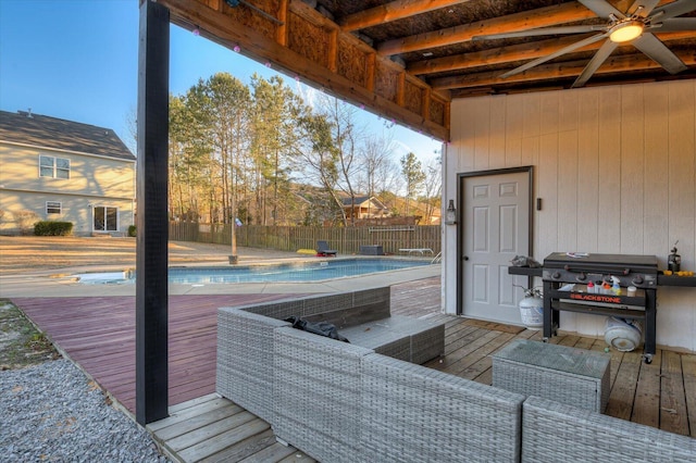 wooden terrace with a fenced in pool and a grill