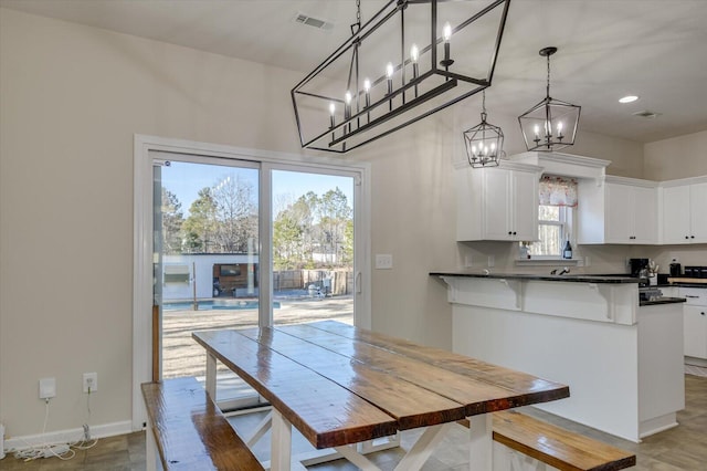 unfurnished dining area featuring light wood-type flooring