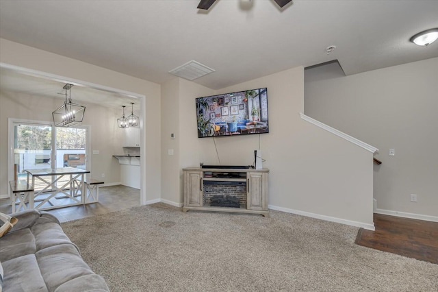 unfurnished living room featuring ceiling fan and carpet