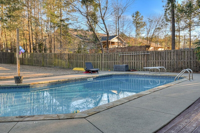 view of pool featuring a diving board