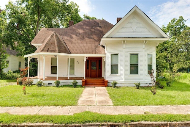 victorian house with covered porch and a front lawn